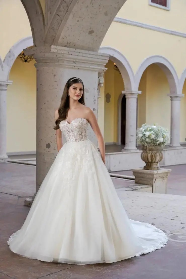 Model wearing a white gown by Justin Alexander. Desktop Image